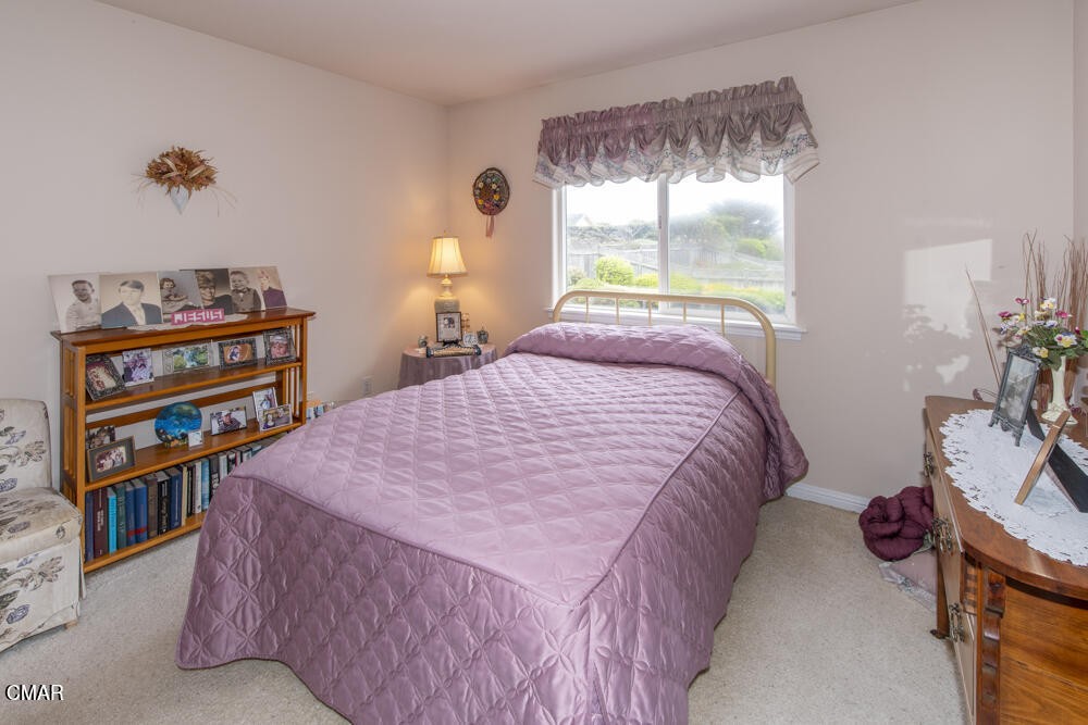970 Glass Beach Drive Fort Bragg, CA 95437 - Photo 13 of 26 a bed sitting in a bedroom next to a window