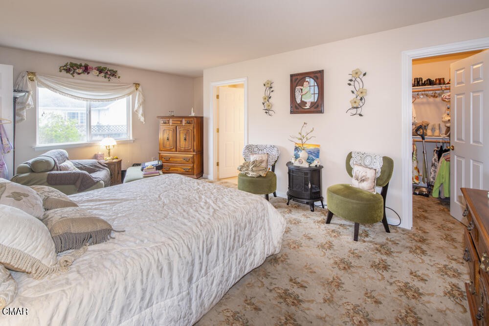 970 Glass Beach Drive Fort Bragg, CA 95437 - Photo 16 of 26 a bedroom with a bed and wooden floor