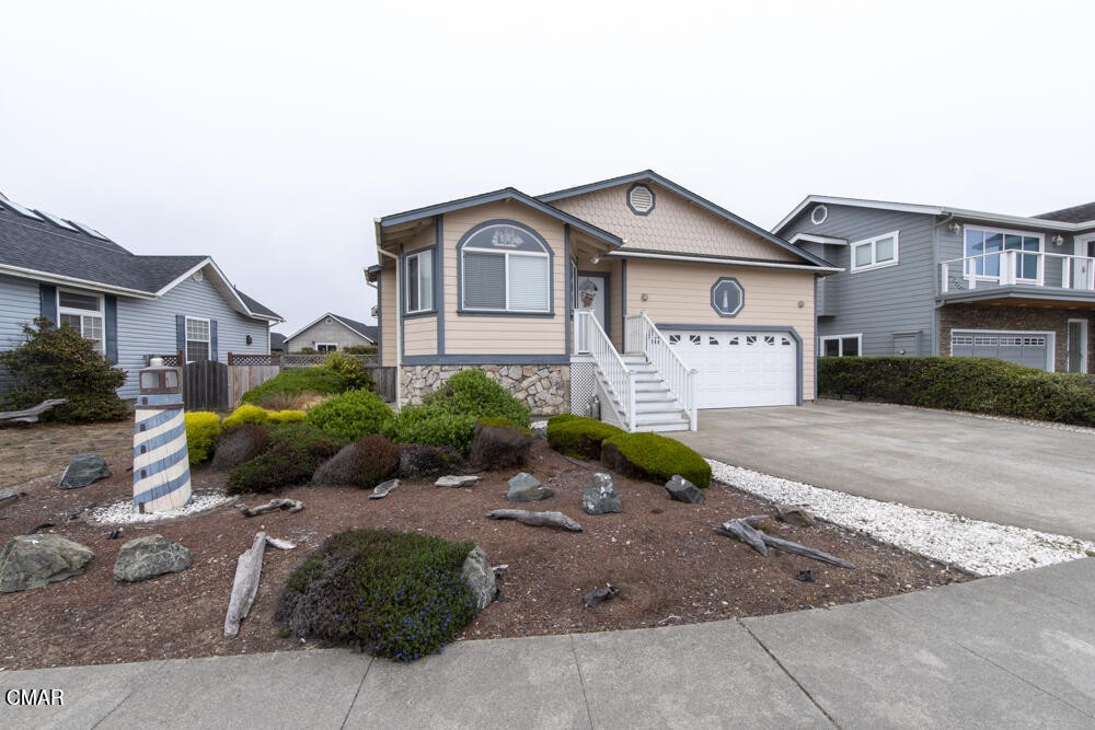 970 Glass Beach Drive Fort Bragg, CA 95437 - Photo 7 of 26 a front view of a house with a yard and garage