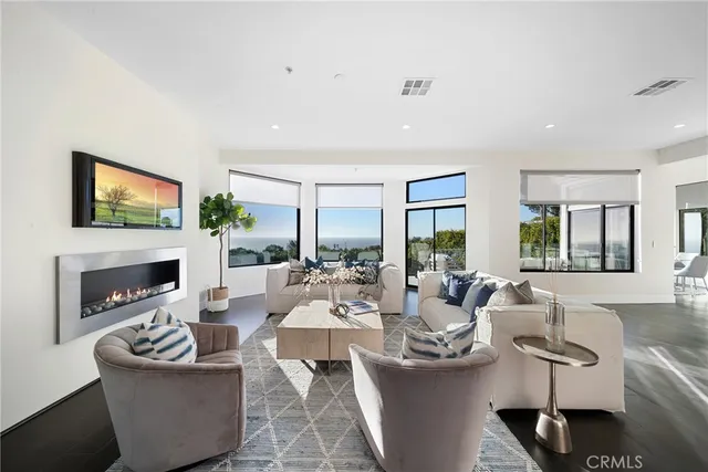 a large kitchen with stainless steel appliances kitchen island granite countertop a sink a stove a dining table and chairs