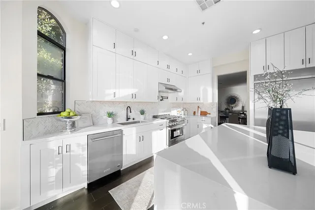 a bathroom with a sink a toilet a mirror and shower