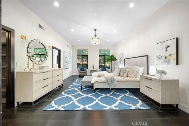 a bedroom with a large bed and a couch