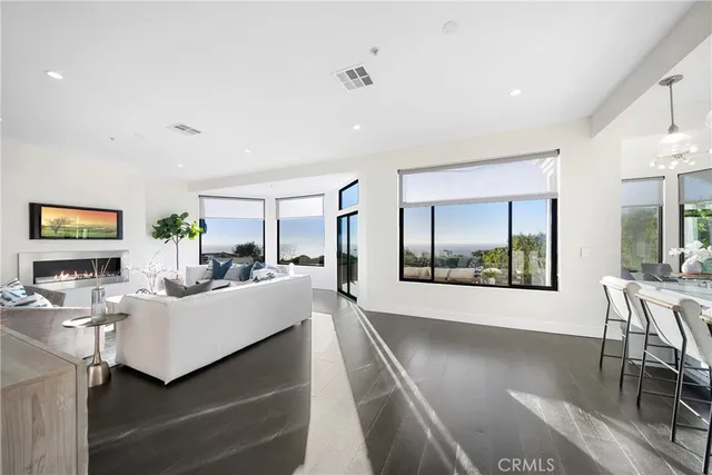 a view of a dining room with furniture a chandelier and wooden floor