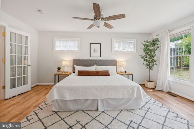 a bedroom with a large bed and a window