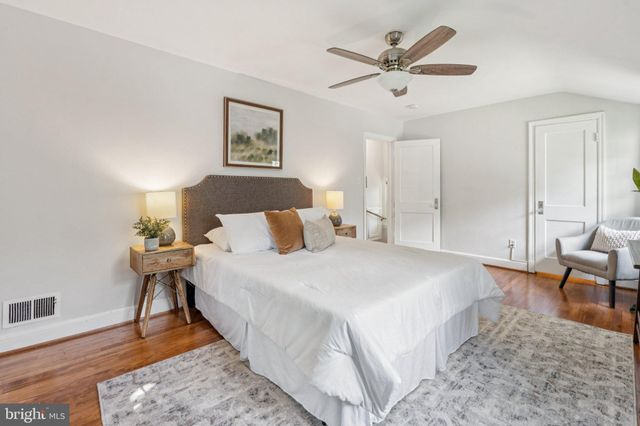 a spacious bedroom with a bed and a table in it