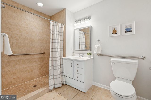 a bathroom with a toilet sink shower and mirror