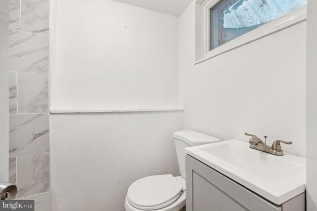 a bathroom with a sink a toilet and mirror