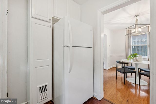 a view of a room with furniture and wooden floor