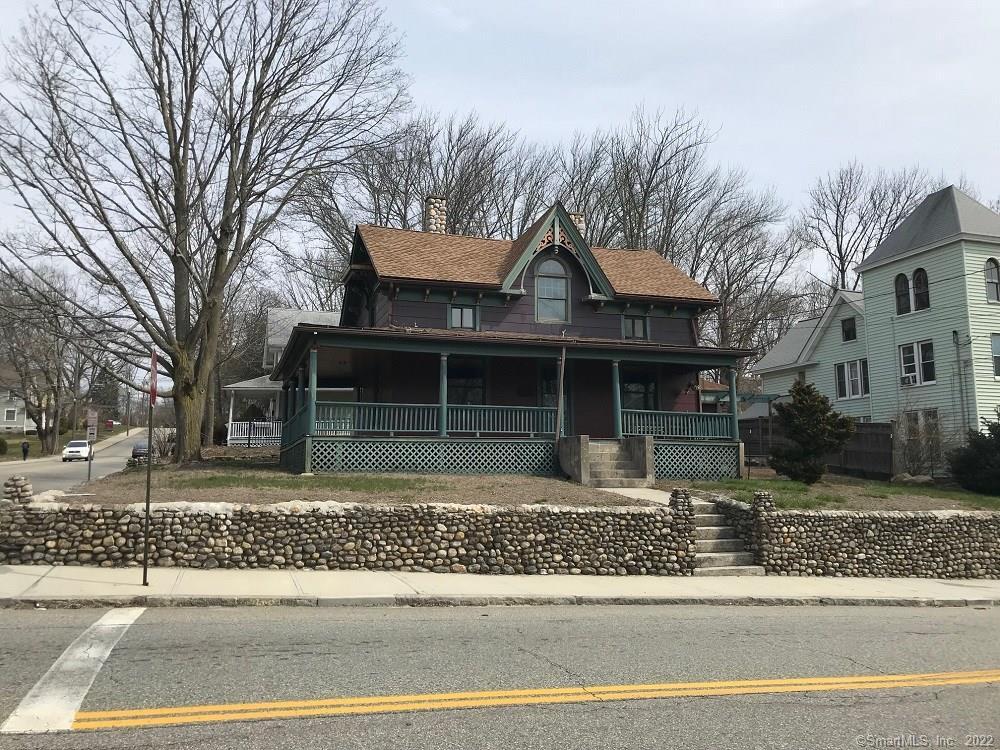 289 Prospect Street Windham, CT 06226 - Photo 1 of 1 a front view of a house with a garden and trees