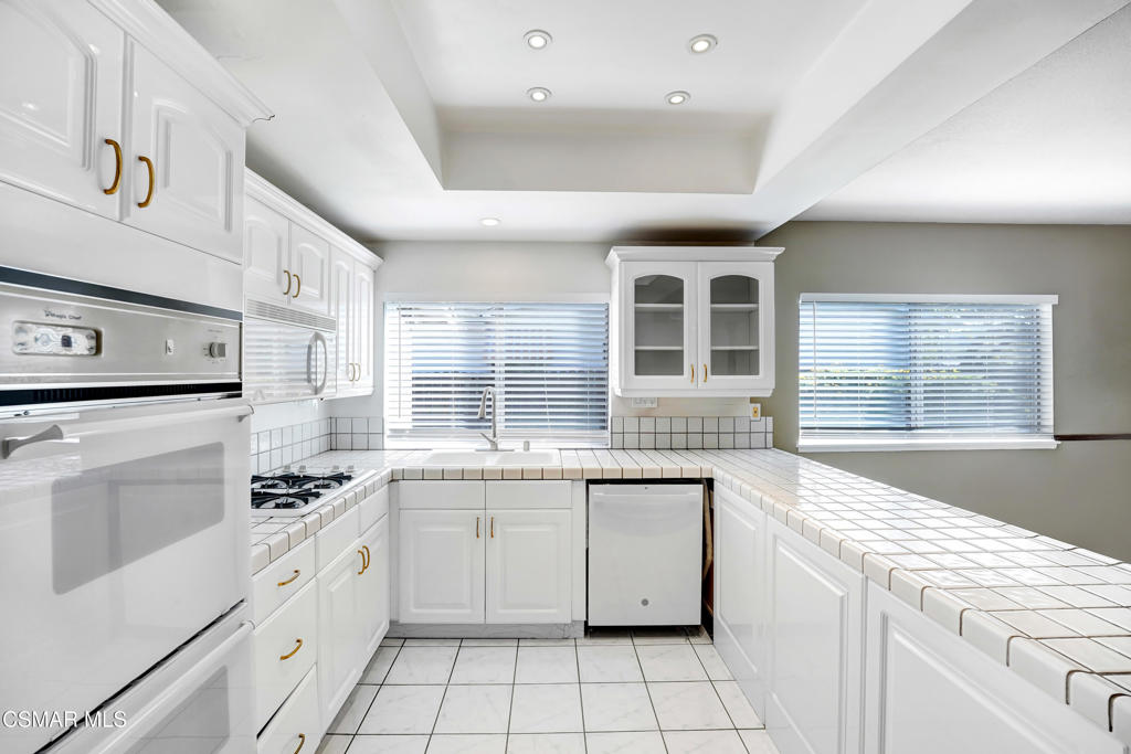 2872 Galena Avenue Simi Valley, CA 93065 - Photo 4 of 20 a kitchen with a stove sink and cabinets