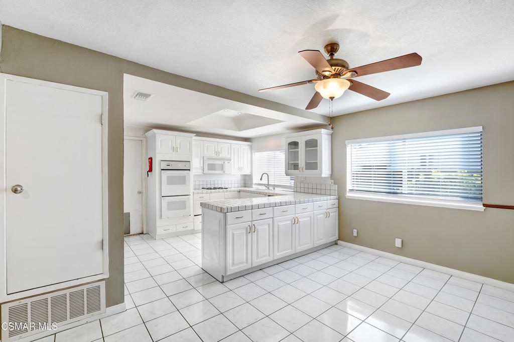 2872 Galena Avenue Simi Valley, CA 93065 - Photo 6 of 20 a kitchen with white cabinets and window