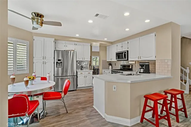 a kitchen that has a dining table and chairs