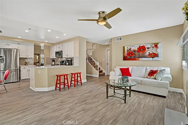 a living room with furniture and kitchen view