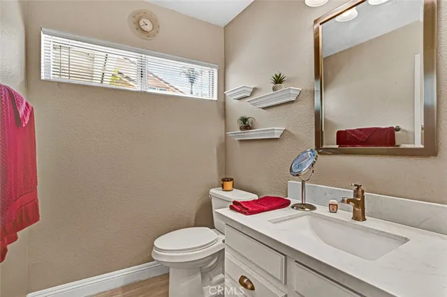 a bathroom with a sink toilet and a mirror