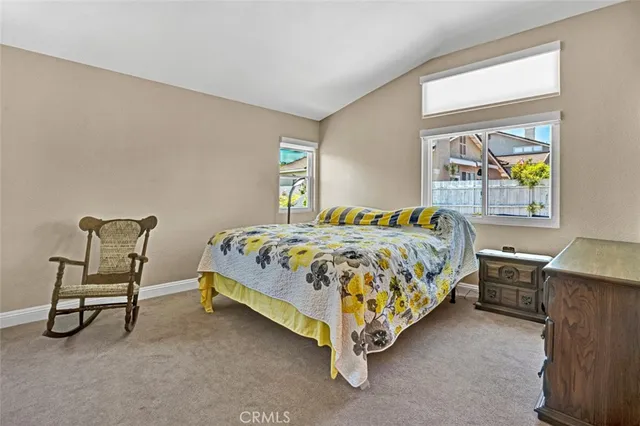 a bed sitting in a bedroom next to a window