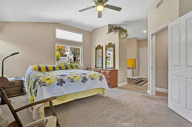 a bedroom with a bed dresser and window