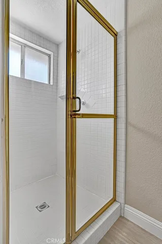 a bathroom with a glass shower door