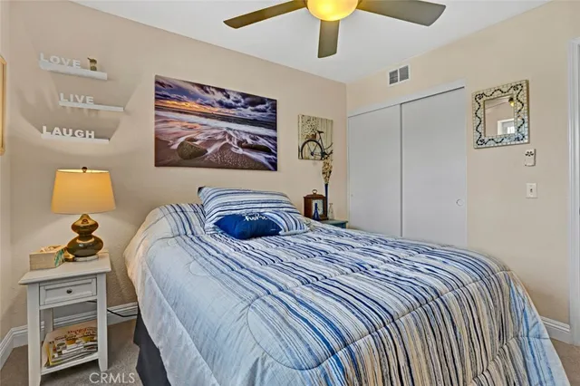 a bedroom with a bed and a lamp