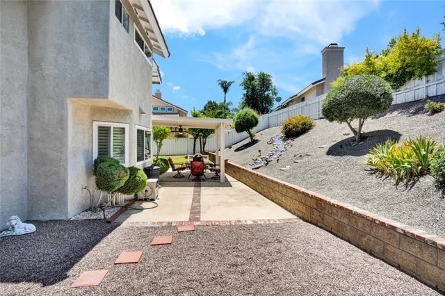 a view of a house with backyard and sitting area
