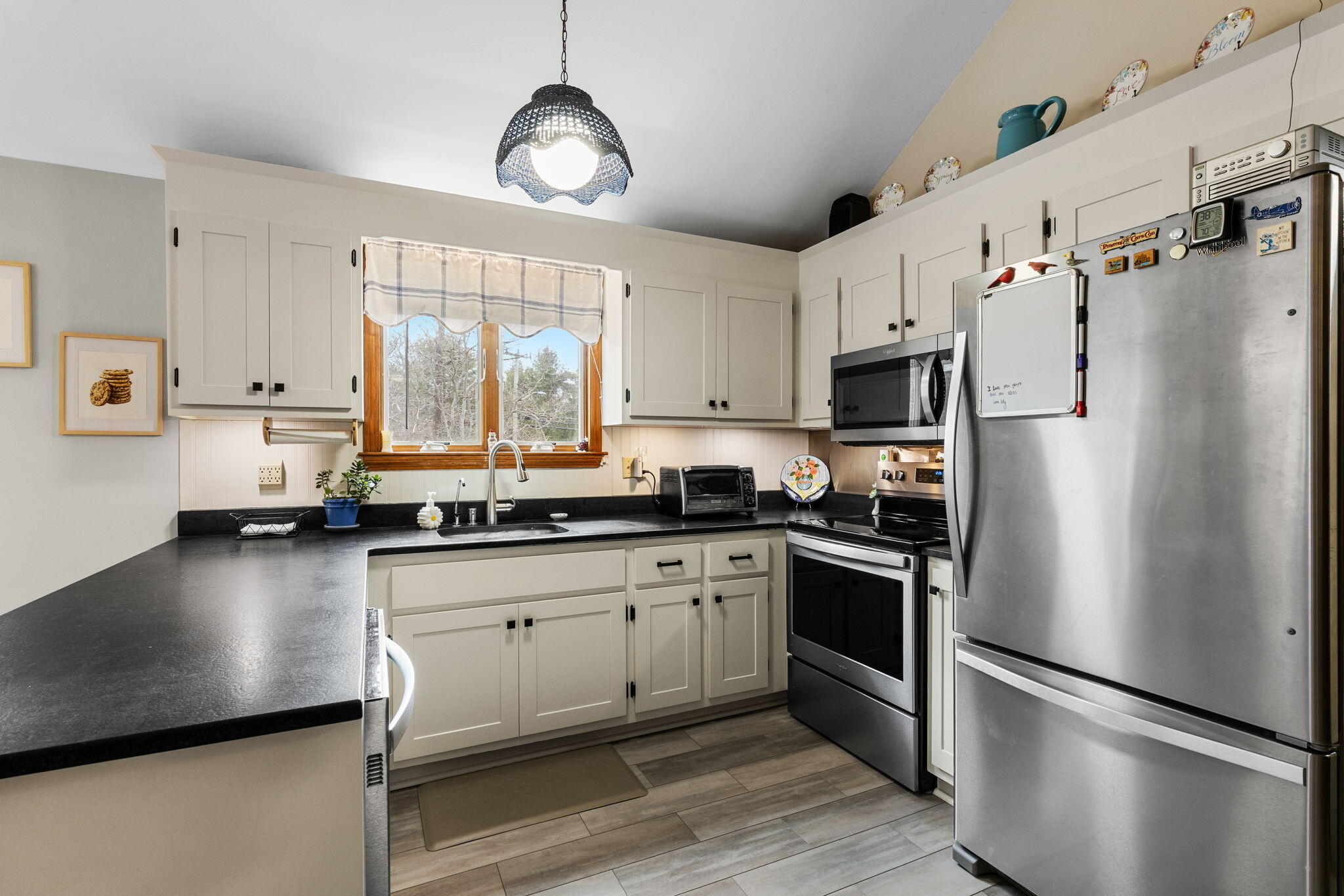 252 Chatham Road Harwich, MA 02645 - Photo 11 of 38 a kitchen with stainless steel appliances a refrigerator sink and microwave
