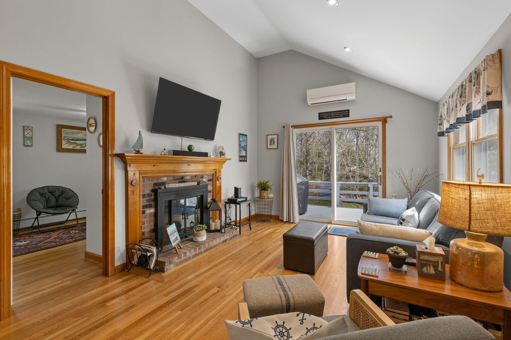 252 Chatham Road Harwich, MA 02645 - Photo 16 of 38 a living room with furniture a flat screen tv and a fireplace