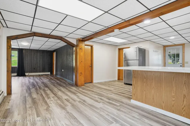 a view of an empty room with wooden floor