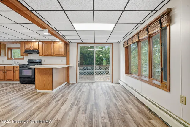 a view of a kitchen with wooden floor and a sink