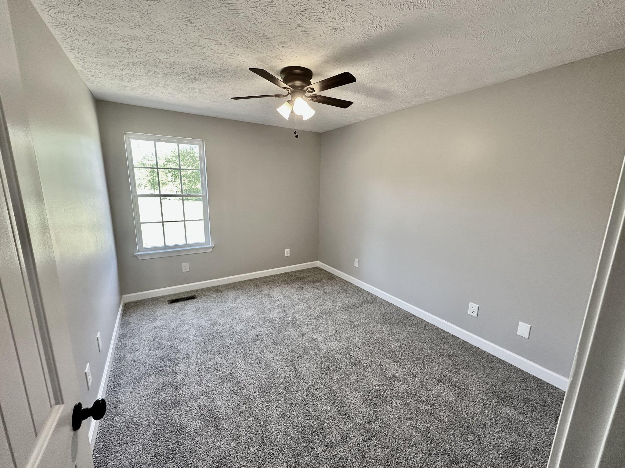 216 Clubbs Road Portland, TN 37148 - Photo 9 of 14 an empty room with windows and fan