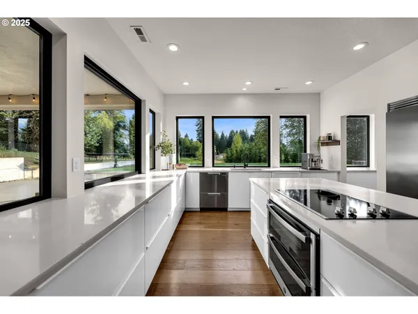 a kitchen with stainless steel appliances granite countertop a sink and stove