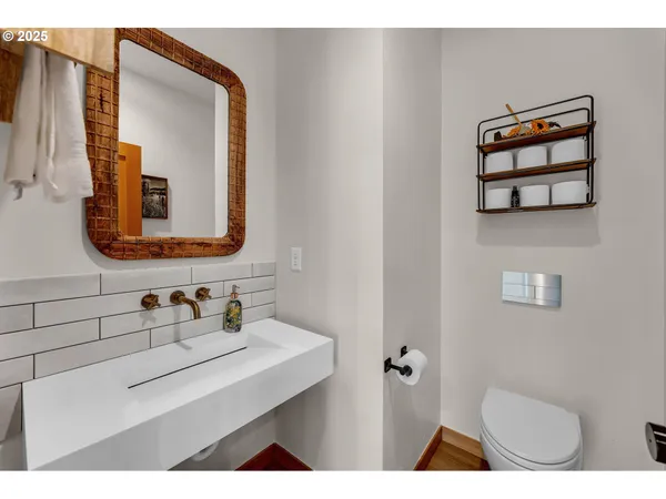 a bathroom with a sink mirror and toilet