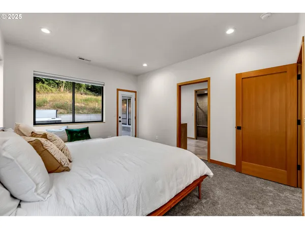 a bedroom with double bed and a window