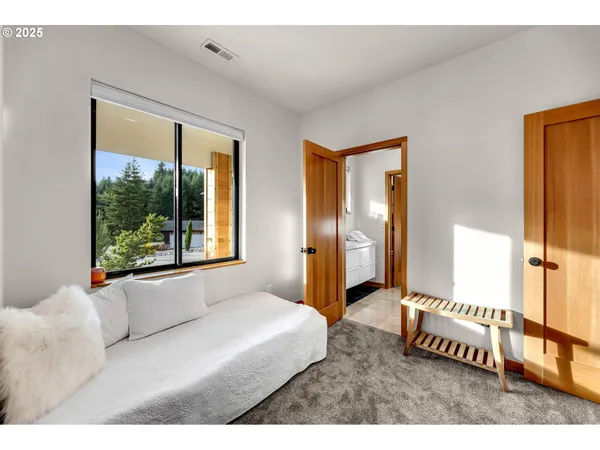 a bedroom with a large bed and a large window