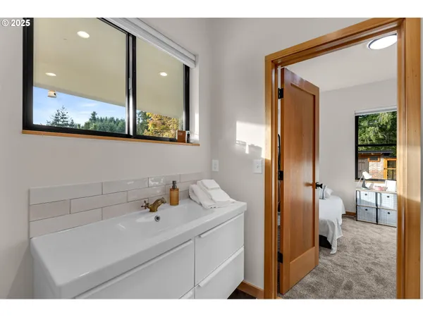 a bathroom with a sink mirror and vanity
