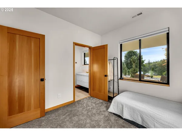 a bedroom with a bed and a large window