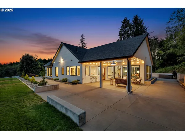 a house view with a sitting space and garden