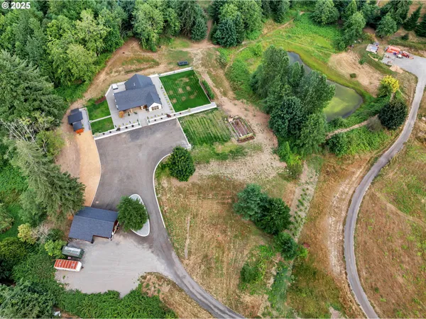 an aerial view of a house with a yard and lake view
