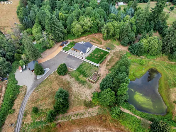 an aerial view of a house with a yard