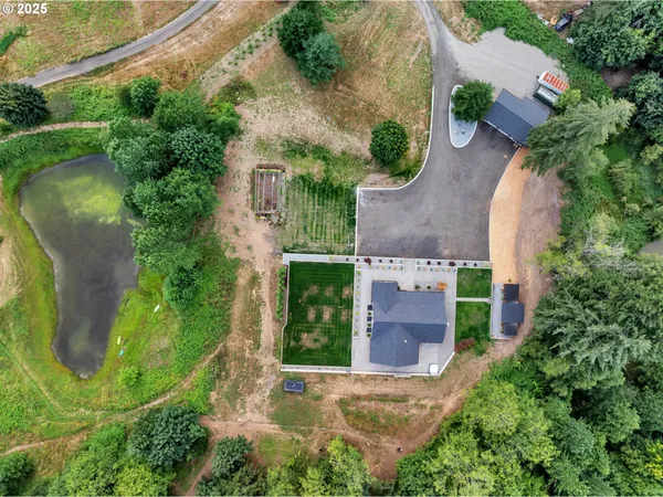 an aerial view of a house with outdoor space and tennis court