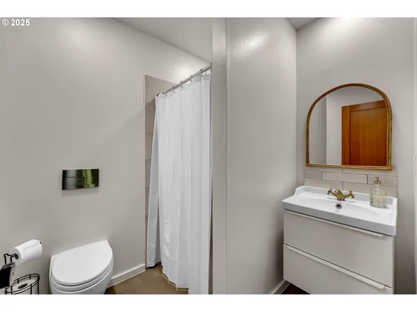 a bathroom with a sink toilet and mirror