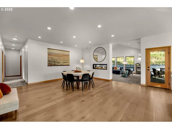 a view of a dining room and livingroom with furniture mirror and window