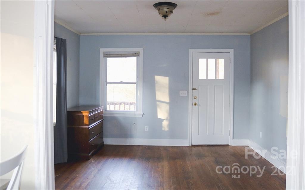 823 Deerwood Road Lancaster, SC 29720 - Photo 4 of 16 an empty room with wooden floor cabinet and windows