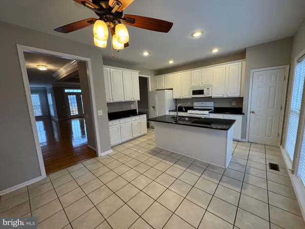 a view of a kitchen with furniture and large window