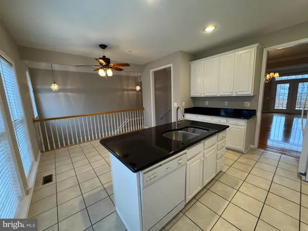 a kitchen with a sink a stove and a refrigerator