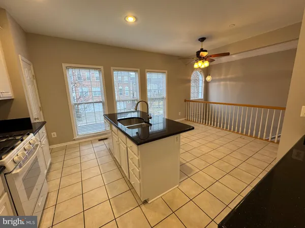 a kitchen with stainless steel appliances a sink a stove a microwave a counter top space and cabinets