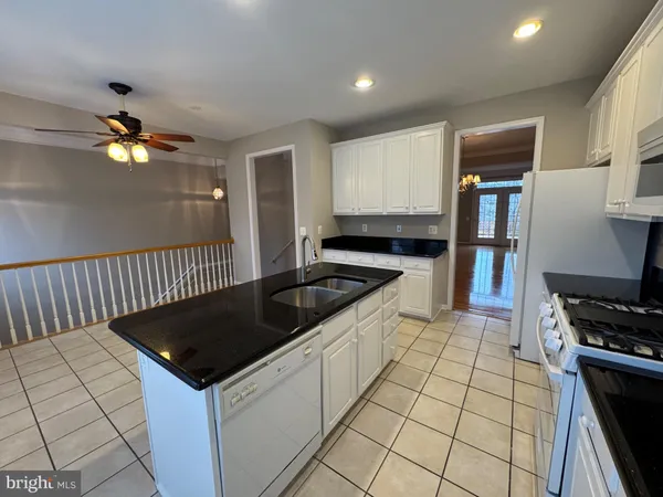 a kitchen with stainless steel appliances a refrigerator sink and cabinets