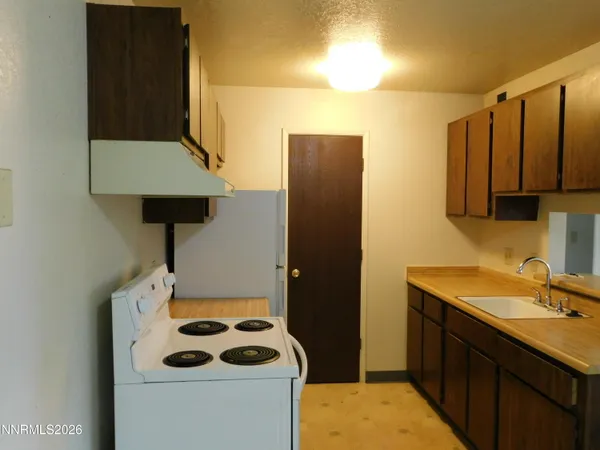 a kitchen with a refrigerator and sink