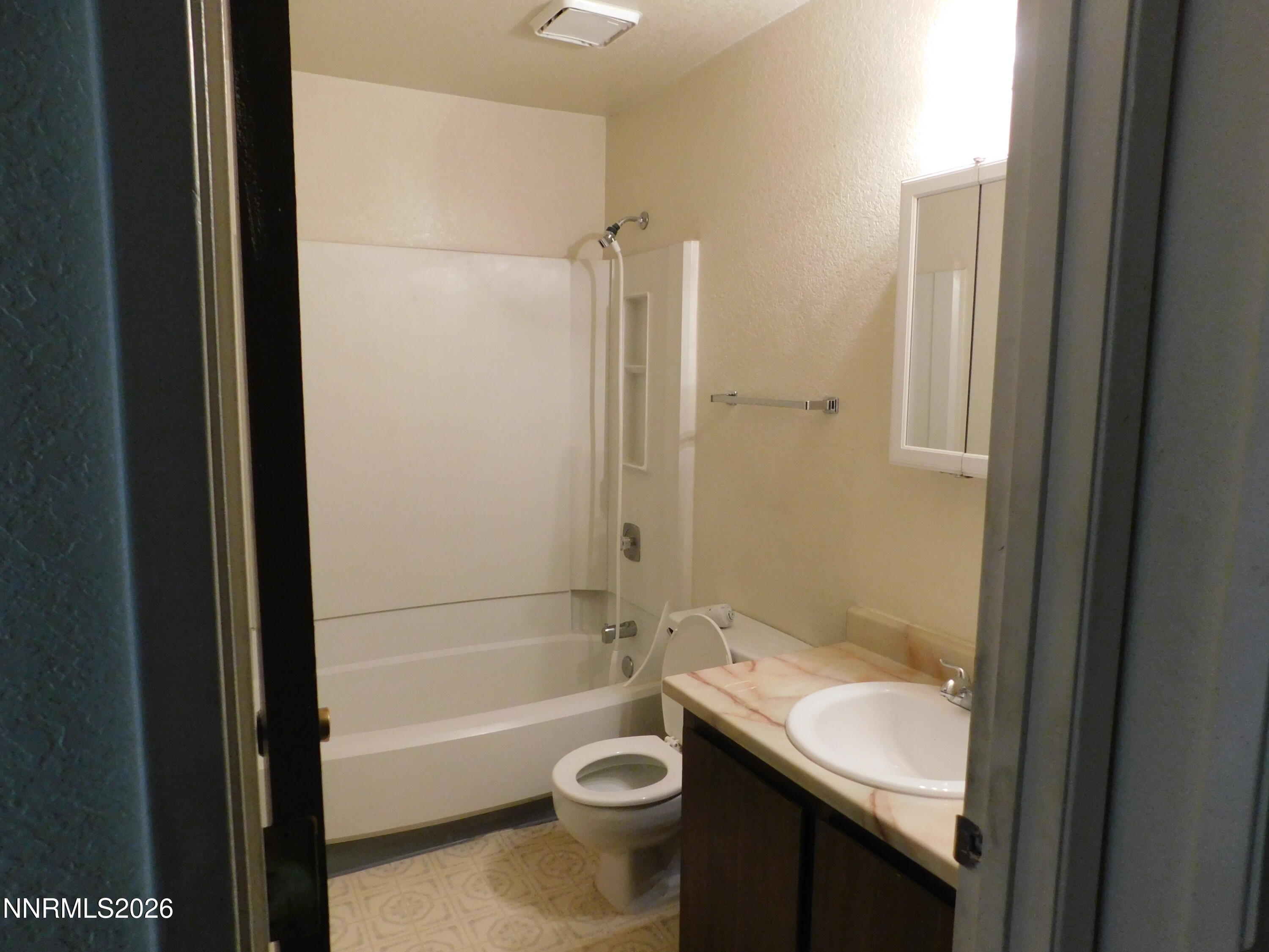 650 North Maine Street, Unit 617 Fallon, NV 89406 - Photo 7 of 8 a bathroom with a sink a toilet and shower