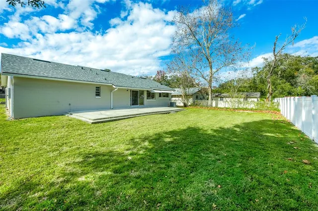 a view of a house with a backyard