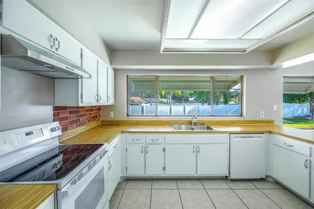 a kitchen with a stove a sink and a microwave