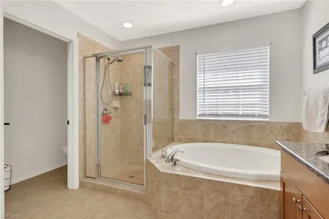 a white bath tub sitting next to a shower